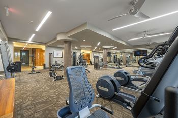 24-Hour fitness center with spin and yoga room featuring fitness on demand virtual workouts